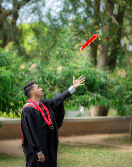 Irosh Perera in graduation attire holding his IJSE diploma